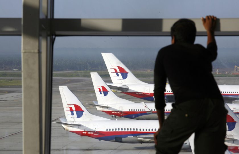 A traveller stands at the viewing gallery overlooking Malaysian Airline System (MAS) aircrafts at Kuala Lumpur International Airport in Sepang outside Kuala Lumpur in this December 23, 2009 file photo. u00e2u20acu201d Reuters pic