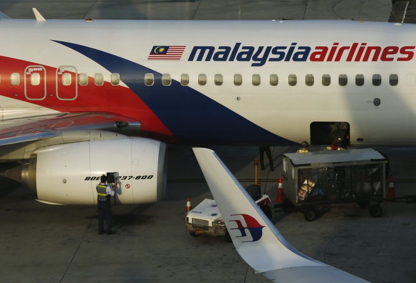 A member of ground crew works on a Malaysia Airlines Boeing 737-800 airplane on the runway at Kuala Lumpur International Airport in Sepang July 25, 2014. u00e2u20acu2022 Reuters pic