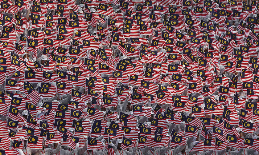 People wave national flags during Independence Day, or Merdeka Day, celebrations in Kuala Lumpur August 31, 2014. u00e2u20acu201d Reuters pic