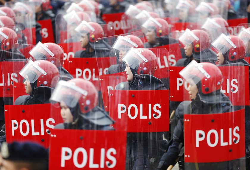 Police officers in riot gear march during Merdeka Day celebrations in Kuala Lumpur August 31, 2014. u00e2u20acu201d Reuters pic