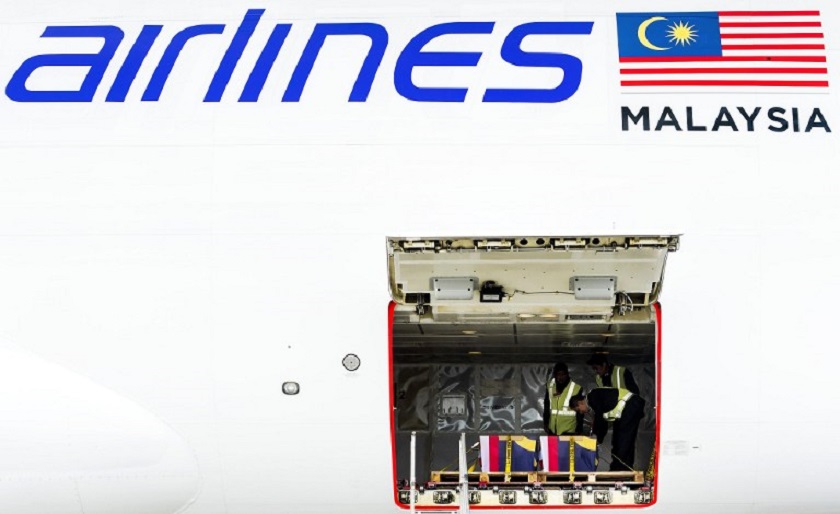 Crew members load coffins carrying the remains of victims of Malaysian Airlines flight MH17 on a plane bound for Malaysia at Schiphol International Airport in Amsterdam on August 21, 2014. u00e2u20acu201d AFP pic 
