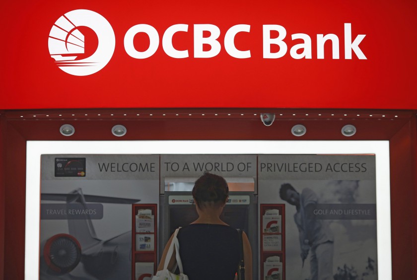 A woman uses an Oversea-Chinese Banking Corp (OCBC) automated teller machine in Singapore's financial district August 5, 2014. u00e2u20acu201d Reuters pic