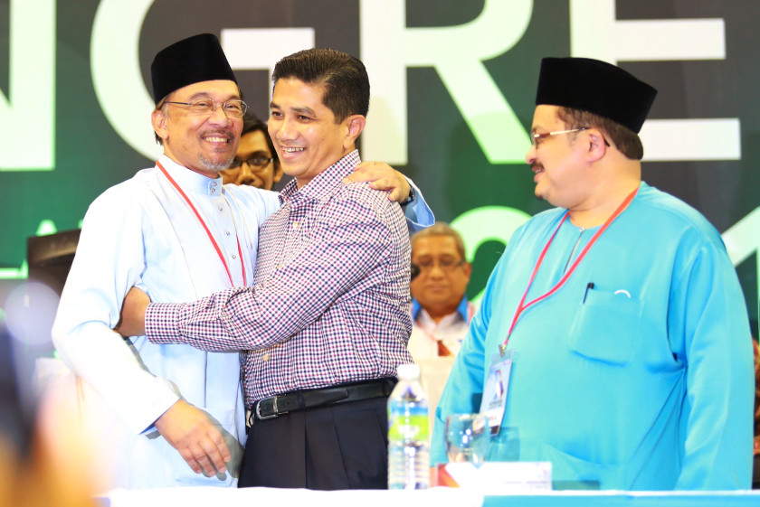 Azmin Ali (centre) hugs Datuk Seri Anwar Ibrahim as Shamsul Iskandar Md Akin looks on at the PKR Congress in Shah Alam, August 23, 2014. u00e2u20acu2022 Picture by Saw Siow Feng