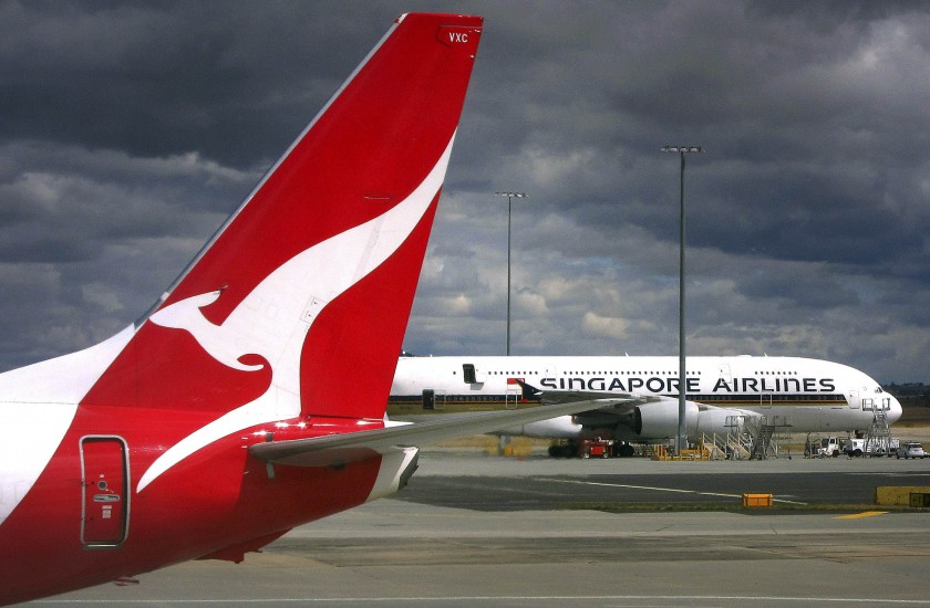 File picture shows a Qantas Airways Boeing 737-800 plane passing a Singapore Airlines Airbus A380 at Sydney Airport. Qantas Airways Ltd on August 28, 2014 reported its biggest financial loss ever. u00e2u20acu201d Reuters pic