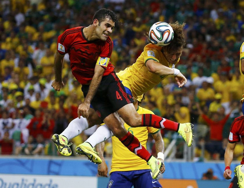 Mexico's Rafael Marquez (left) fights for the ball with Brazil's David Luiz during their 2014 World Cup Group A soccer match at the Castelao arena in Fortaleza June 17, 2014. u00e2u20acu2022 Reuters pic