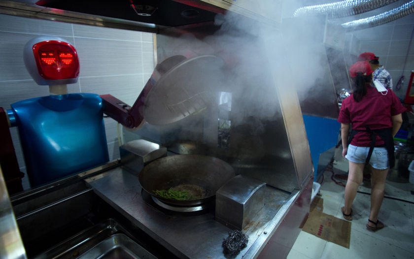 A restaurant in China is using more than a dozen robots to cook and deliver food. u00e2u20acu201d AFP picn