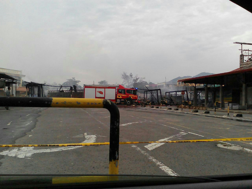 A Sabah Fire and Rescue Services Department vehicle is seen near the smoking ruins of the shophouses in Sabah, on August 1, 2014. 