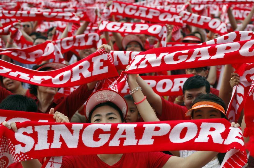 People cheer during Singapore's 49th National Day Parade at the floating platform in Marina Bay August 9, 2014. — Reuters pic