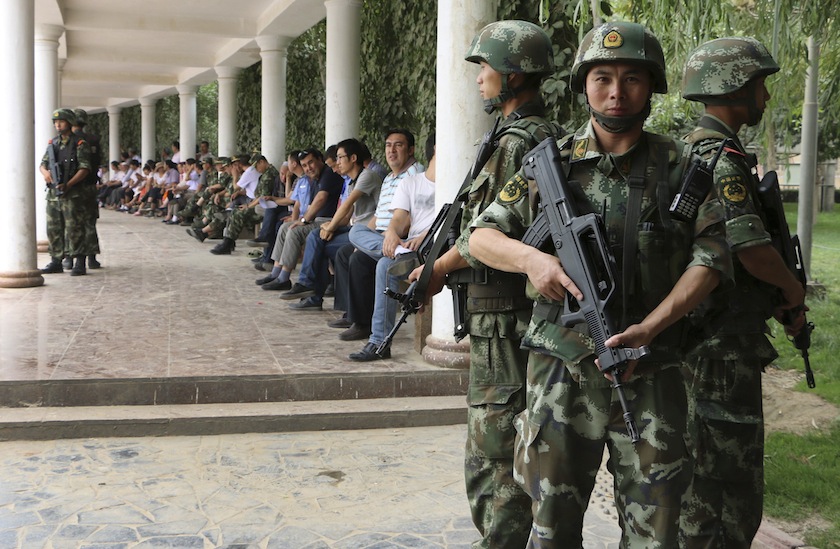 Paramilitary policemen stand guard during a ceremony to award those who the authorities say participated in 'the crackdown of violence and terrorists activities' in Hotan, Xinjiang Uighur Autonomous Region August 3, 2014. u00e2u20acu201du00c2u00a0Reuters pic