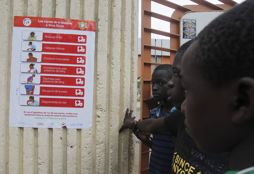 Boys stand next to a poster, pertaining to the Ebola virus, during a training session by Sierra Leoneu00e2u20acu2122s national soccer team at the Felix Houphouet Boigny stadium in Abidjan, September 6, 2014. u00e2u20acu201d Reuters pic