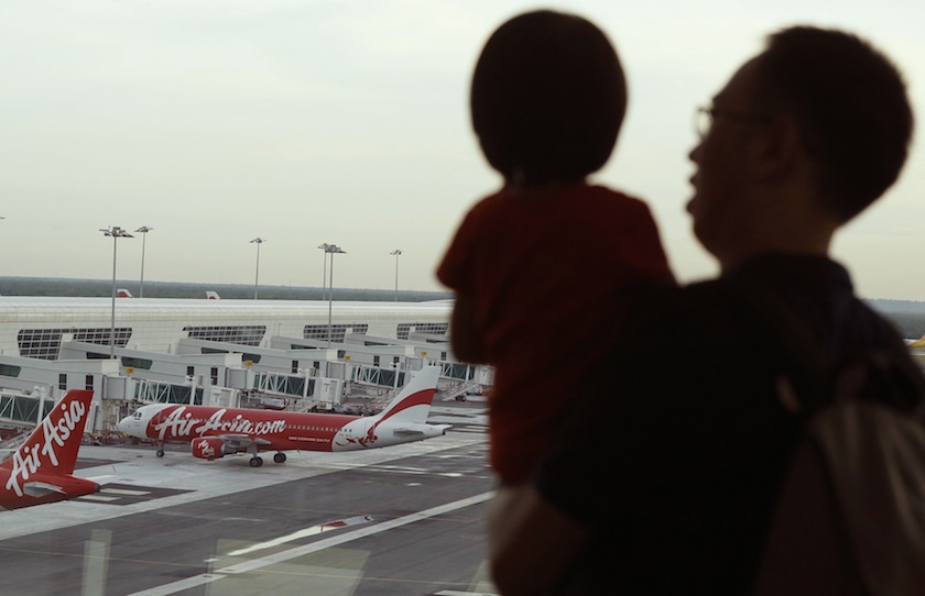 A man and his daughter look at AirAsia planes at Kuala Lumpur International Airport August 19, 2014. u00e2u20acu201du00c2u00a0Reuters pic