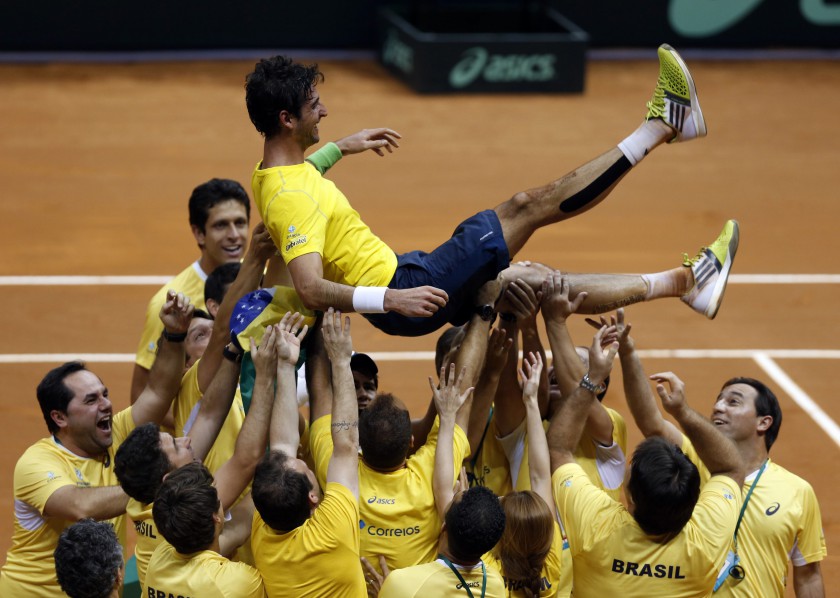Brazilu00e2u20acu2122s team members throws up Thomaz Bellucci after he defeated Roberto Bautista of Spain at their Davis Cup play-off match in Sao Paulo September 14, 2014. u00e2u20acu201d Reuters pic