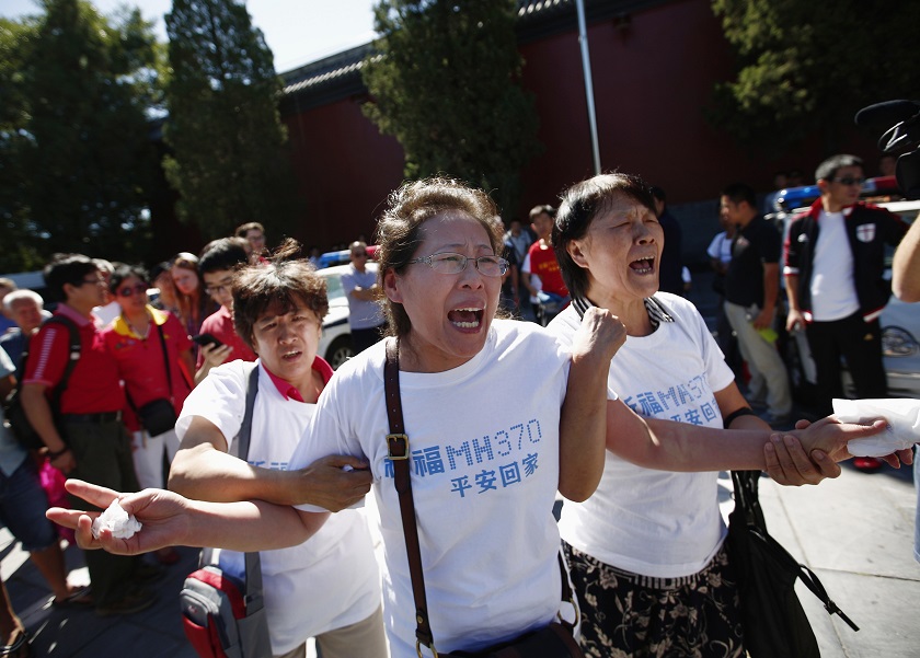 Family members of passengers onboard the missing Malaysia Airlines Flight MH370, cry as they gather to pray Yonghegong Lama Temple in Beijing September 8, 2014, on the six-month anniversary of the disappearance of the plane. u00e2u20acu201d Reuters pic