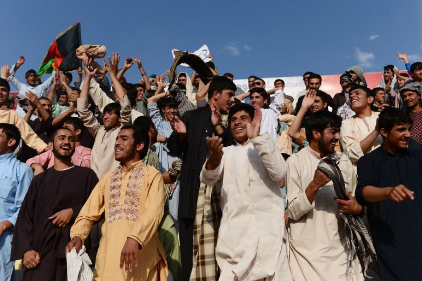 Supporters cheer Afghan football players from De Maiwand Atalan team and Simorgh Alborz team during the Roshan Afghan premiere league at the Afghanistan Football Federation stadium in Kabul on August 29, 2014. u00e2u20acu201d AFP pic
