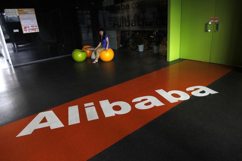 An employee sits next to a logo of Alibaba during a media tour organised by government officials at the company's headquarters outside Hangzhou, Zhejiang province. u00e2u20acu201d Reuters pic