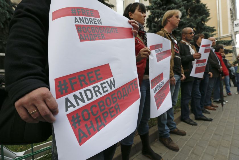 People, including journalists, take part in a rally to support Russian photographer Andrei Stenin near the embassy of Ukraine in Moscow, August 26, 2014. ― Reuters pic