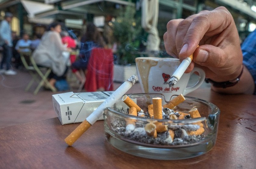 Guests of a coffee shop enjoy their cigarettes at Vienna's most famous market Naschmarkt September 9, 2014. u00e2u20acu201d AFP pic