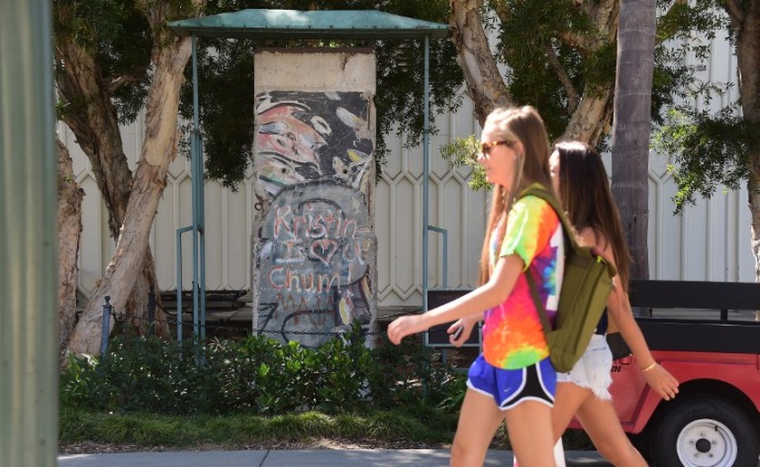 Students walk past a section of the Berlin Wall on display at Loyola Marymount University in Los Angeles, California on September 25, 2014. u00e2u20acu201d AFP picn