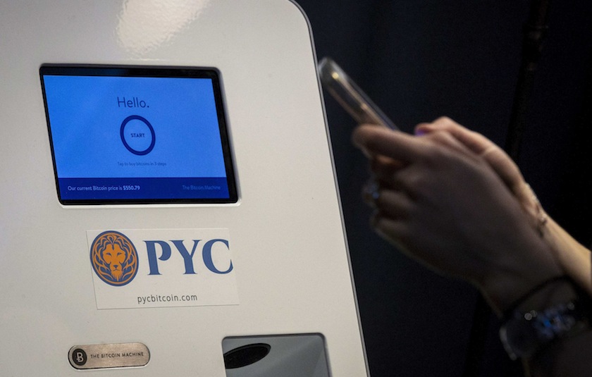 A customer prepares to use a Bitcoin ATM located in Flat 128, a boutique in New York's West Village August 22, 2014. u00e2u20acu201d Reuters pic