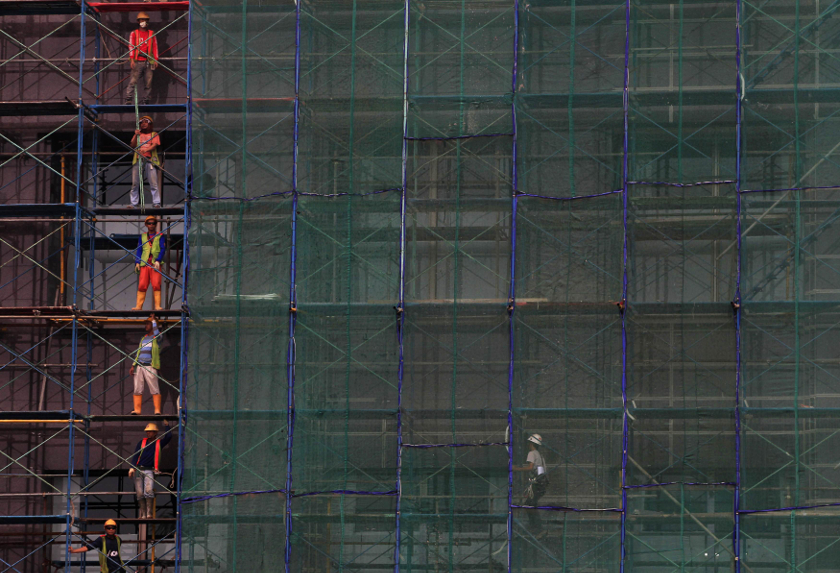 Workers stand at a scaffolding of a new building being constructed in Jakarta in this March 23, 3014 file photo. u00e2u20acu201d Reuters pic