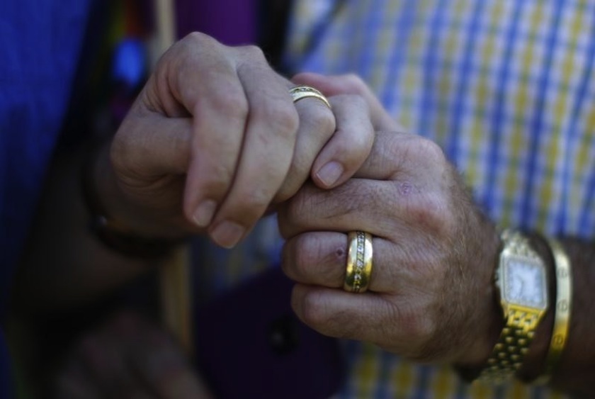 Married couple Bill Hacket, 53, (left) and Thom Uber hold hands in West Hollywood, California after the United States Supreme court ruled on California's Proposition 8 and the federal Defense of Marriage Act, June 26, 2013.u00c2u00a0u00e2u20acu201d Reuters pic