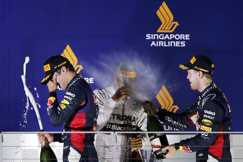 Winner Mercedes Formula One driver Lewis Hamilton (centre) of Britain, second placed Red Bull Formula One driver Sebastian Vettel (right) of Germany and third placed team mate Daniel Ricciardo in Singapore September 21, 2014. u00e2u20acu201d Reuters pic