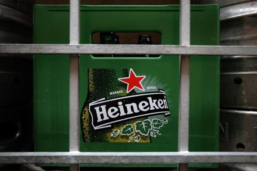 A plastic container with empty bottles of Heineken beers are pictured among beer kegs outside a restaurant in Singapore August 29, 2012. u00e2u20acu201d Reuters pic