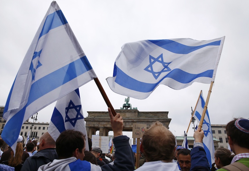 People hold Israeli flags as they listen to speakers during an anti-Semitism demo at Berlin's Brandenburg Gate September 14, 2014.u00c2u00a0u00e2u20acu201d Reuters pic