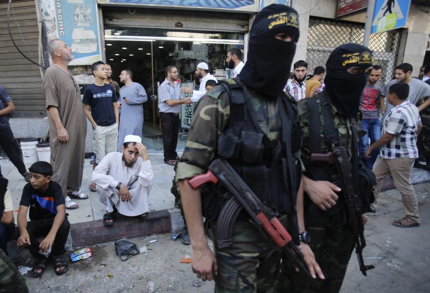 A Palestinian man watches as Islamic Jihad militants take part in a rally celebrating what they say was a victory over Israel following a ceasefire in Gaza City August 29, 2014. u00e2u20acu2022 Reuters pic