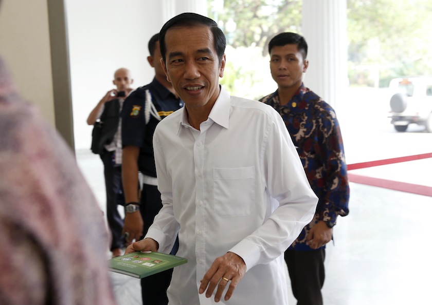 Jakarta governor and president-elect Joko Widodo smiles as he arrives for work at city hall in Jakarta September 8, 2014. u00e2u20acu201d Reuters pic