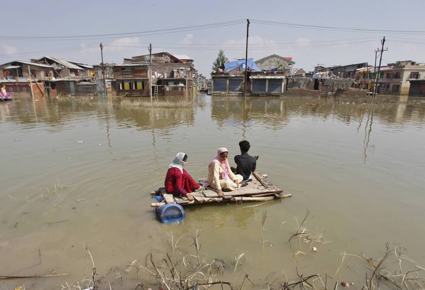 Kashmiris use a makeshift raft to move to a safer place after flooding in Srinagar September 20, 2014. u00e2u20acu201d Reuters pic