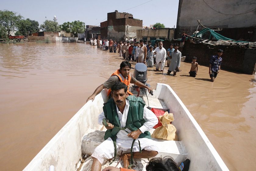 A rescue worker steers a a boat as flood victims wait for their turn in floodwaters, caused by heavy rain, to be transported to dry ground in Wazirabad, located in Gujranwala on September 7, 2014. u00e2u20acu201du00c2u00a0Reuters pic