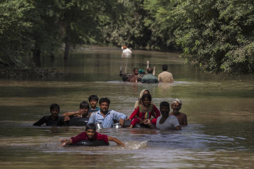 Flood victims wade through a flooded area along a road as they wait for help, in Multan, Punjab province September 13, 2014. u00e2u20acu201d  Reuters pic