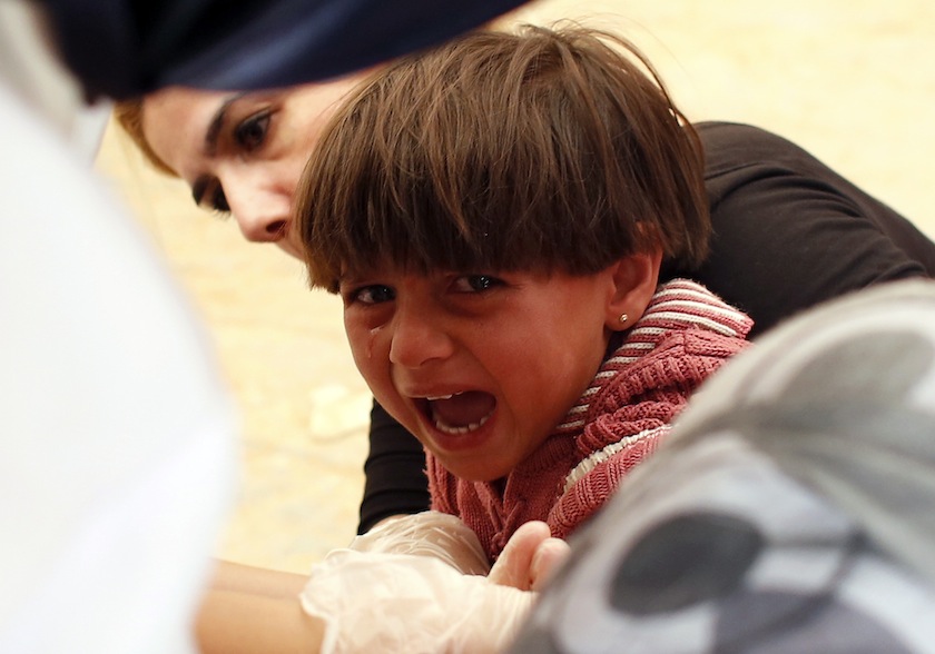 A Kurdish Syrian refugee girl cries as she receives a vaccine at a first aid tent after crossing the Turkish-Syrian border near the southeastern town of Suruc in Sanliurfa province September 25, 2014. u00e2u20acu201d Reuters pic