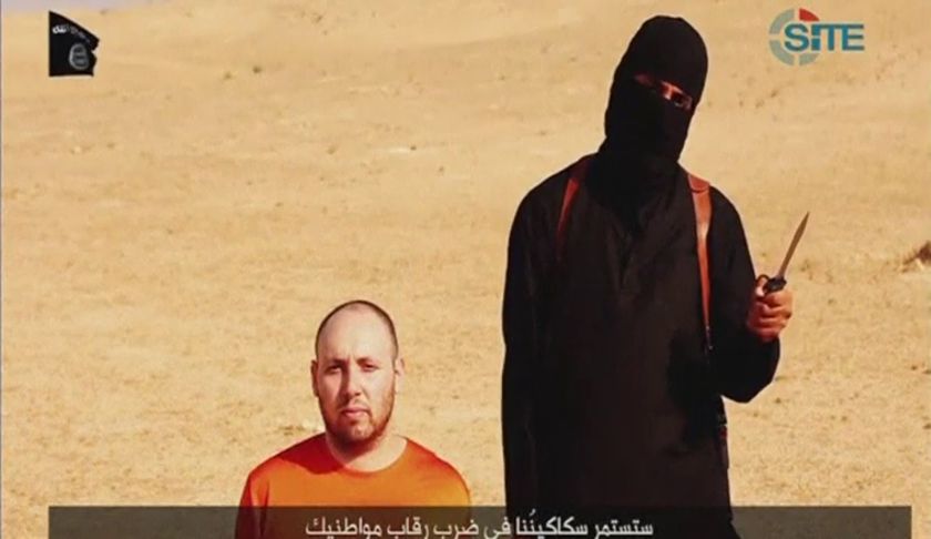 A video purportedly showing US journalist Steven Sotloff kneeling next to a masked Islamic State fighter holding a knife in an unknown location in this still image from video released by Islamic State September 2, 2014. u00e2u20acu201d Reuters pic