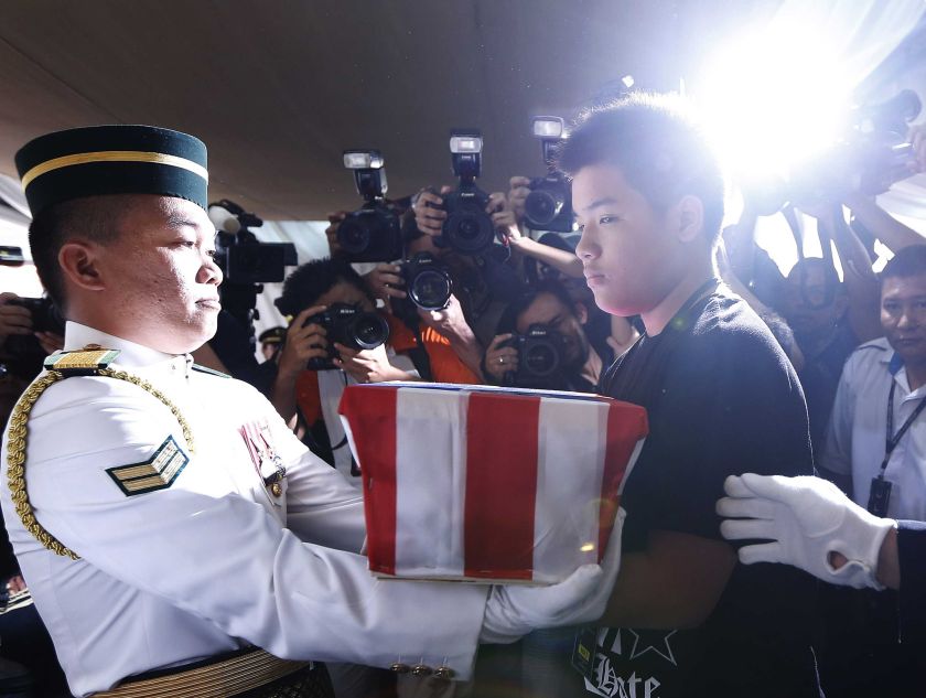 Melvic Choo, 13, takes the ashes of his father MH17 co-pilot Eugene Choo at his wake in Seremban September 2, 2014. u00e2u20acu2022 Reuters pic