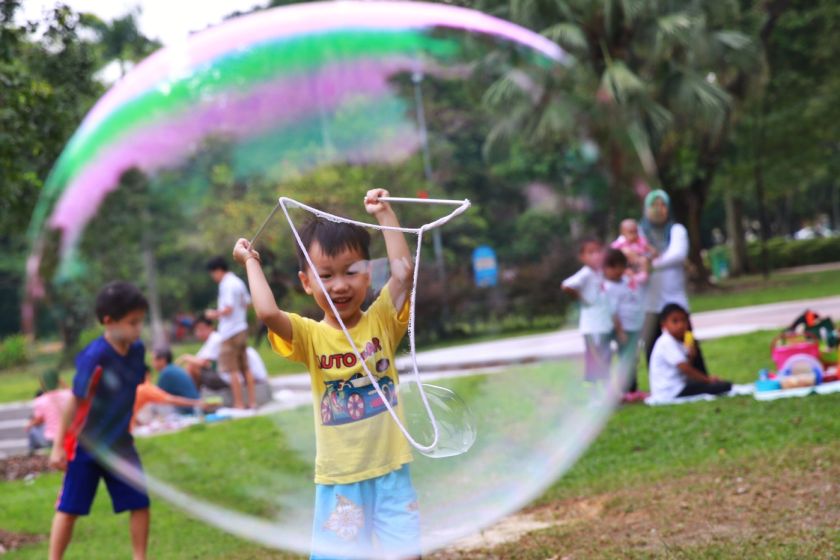 A young boy playing with a big bubble at the Malaysia Day picnic at Taman Jaya, September 16, 2014. u00e2u20acu201d Picture by Saw Siow Feng