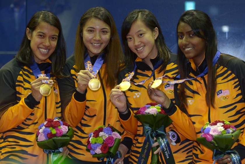 David Nicol Ann, Arnold Delia Odette, Low Wee Wern and Vanessa Raj Gnanasigamani pose during the medal ceremony for the women's squash team final round at the 2014 Asian Games in Incheon on September 27, 2014.u00c2u00a0u00e2u20acu201d AFP pic