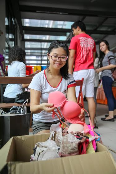 Nicole Lee sorting through a box of donated bras.