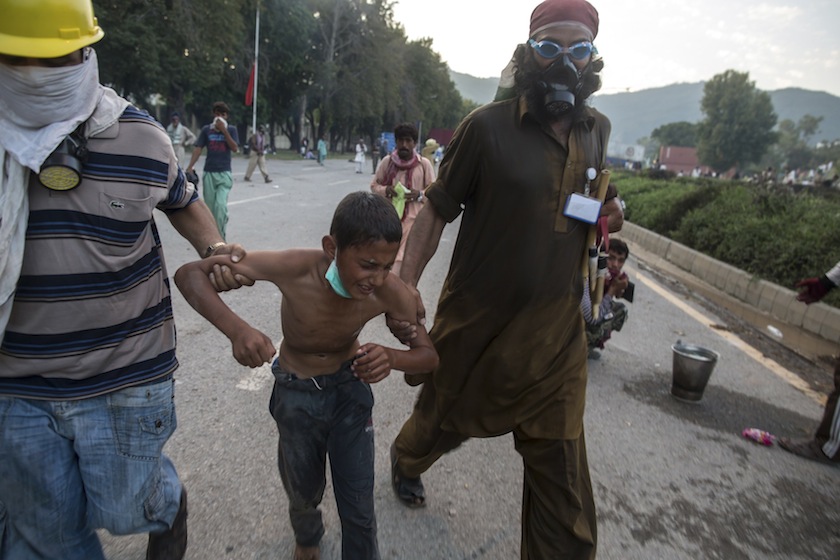 Supporters of Tahir ul-Qadri, Sufi cleric and opposition leader of political party Pakistan Awami Tehreek, escort a boy suffering from the effects of tear gas fired by riot police in Islamabad August 31, 2014. u00e2u20acu201d Reuters pic