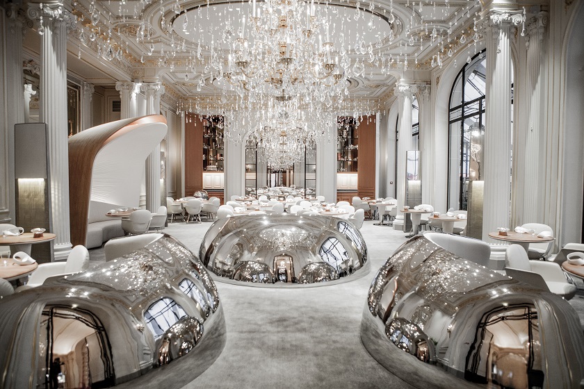 At the entrance to the dining room, a space is defined by the convex sides of three stainless steel cloches like those used to cover dishes. On the concave side, each ‘cloche’ surrounds a table, and one of them forms the back of a bench seat. — Picture courtesy of Pierre Monetta