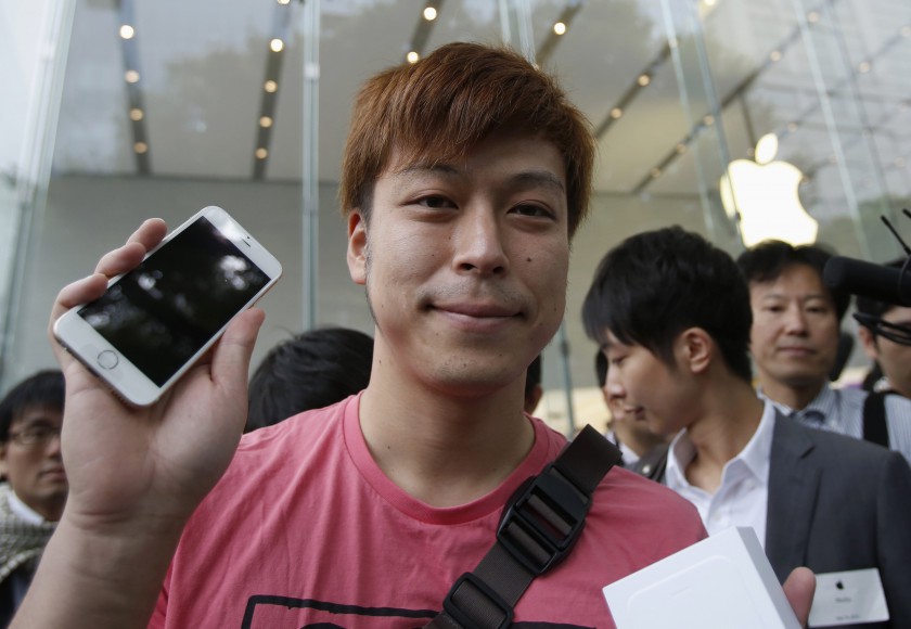 A man poses with his iPhone 6 outside the Apple Store at Tokyo's Omotesando shopping district September 19, 2014. Apple Inc is still awaiting a critical license before it can sell its new iPhone 6 in China. u00e2u20acu201d Reuters pic