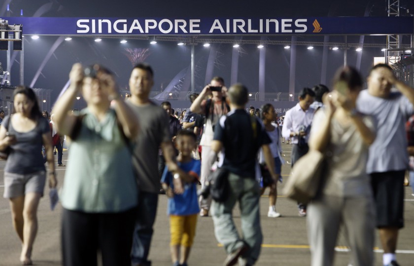 Fans take photos in the circuit during a pit walk ahead of the Singapore F1 Grand Prix night race September 18, 2014. Singapore will be counting on its marquee Formula One race to help make up for a 30 per cent drop in Chinese tourists this year. u00e2u20acu201d Reut