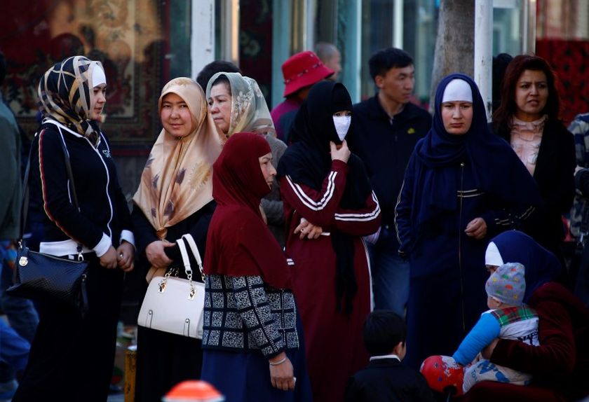 Uighur women stand next to a street to wait for a bus in downtown Urumqi, Xinjiang Uighur Autonomous Region May 1, 2014. u00e2u20acu2022 Reuters pic