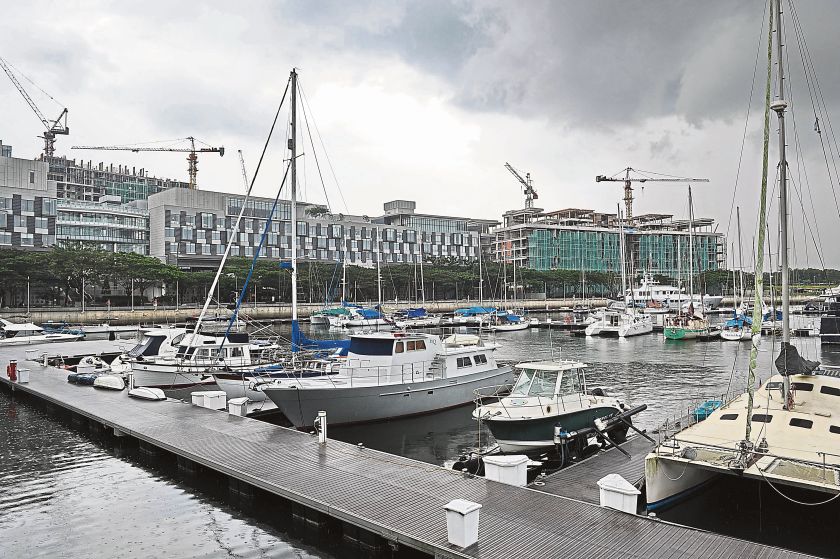 Yachts berthed at a club at the Iskandar development zone in Johor while construction takes place in the background. Members of investorsu00e2u20acu2122 clubs involved in bulk-buying of property are taking a risk of falling into debt, says the Urban Wellbeing, Housin