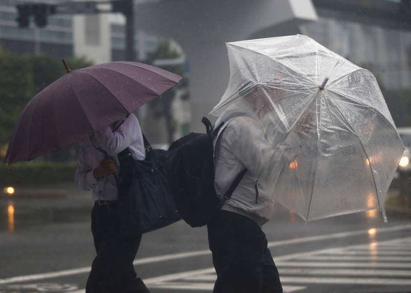 Passers-by with umbrellas struggle against strong winds and heavy rain caused by Typhoon Phanfone, in Tokyo October 6, 2014. u00e2u20acu201d Reuters pic