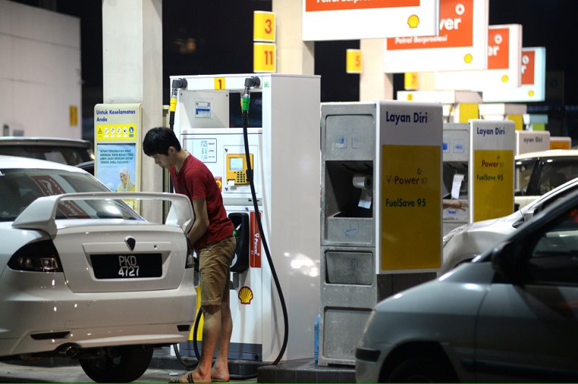 A motorist fills up his car with petrol before the 20 sen petrol price increase at midnight, George Town, October 1, 2014. — Picture by K.E. Ooi