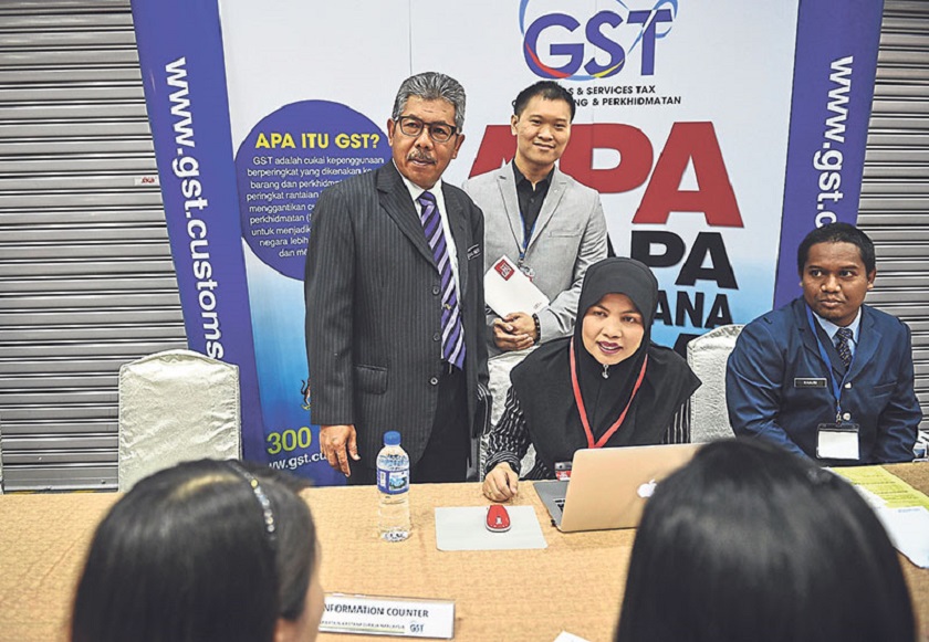 Royal Malaysian Customs Department deputy director general Datuk Zainul Abidin Taib (left) at the opening of GST Expo and Conference 2014 at Kuala Lumpur Convention Centre (KLCC). nu00e2u20acu201d Picture by Firdaus Latif