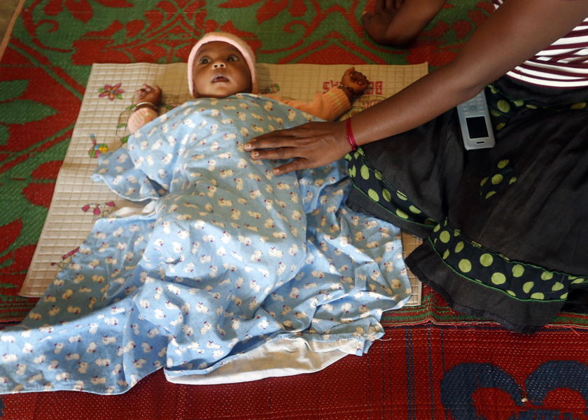 A woman sits next to her baby at a camp for people who have been displaced by a landslide at the Koslanda tea plantation, October 30, 2014. u00e2u20acu201d Reuters pic