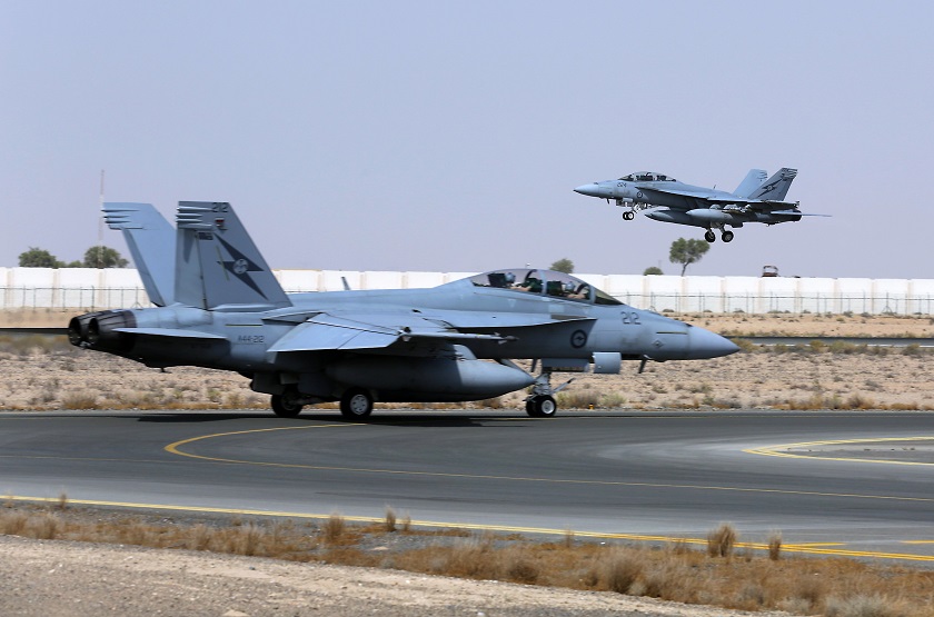 A Royal Australian Air Force (RAAF) F/A-18F Super Hornet takes off as another taxis along the runway as they start their first combat mission over Iraq in this picture released by the Australian Defence Force October 6, 2014. u00e2u20acu201d Reuters pic